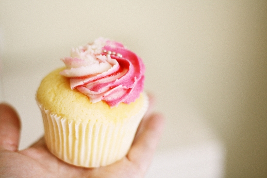 holding pink cupcake