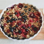 Baked oatmeal with mixed berries, banana, maple syrup and walnuts